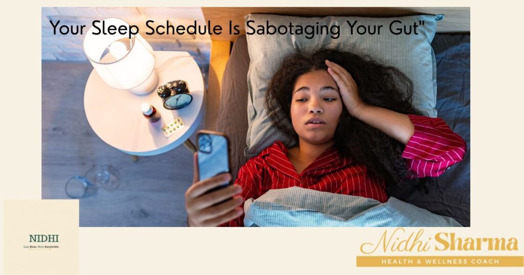 Young woman lying awake in bed at night scrolling on her phone, with a lamp, alarm clock and medication on the bedside table